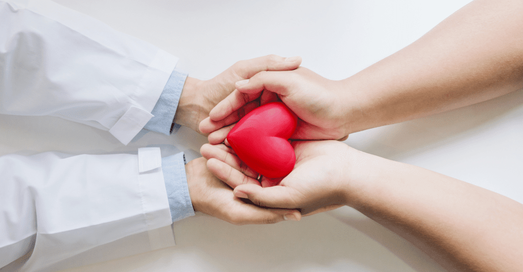 Holding hands with your doctor with heart in hands.