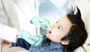Child with open mouth at the dentist
