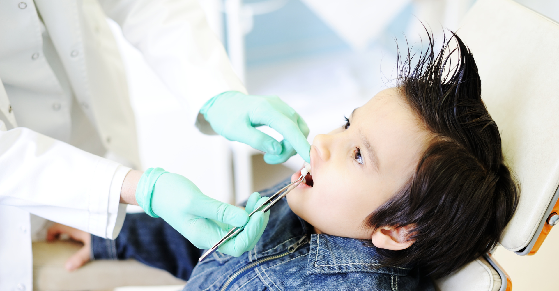 Child with open mouth at the dentist