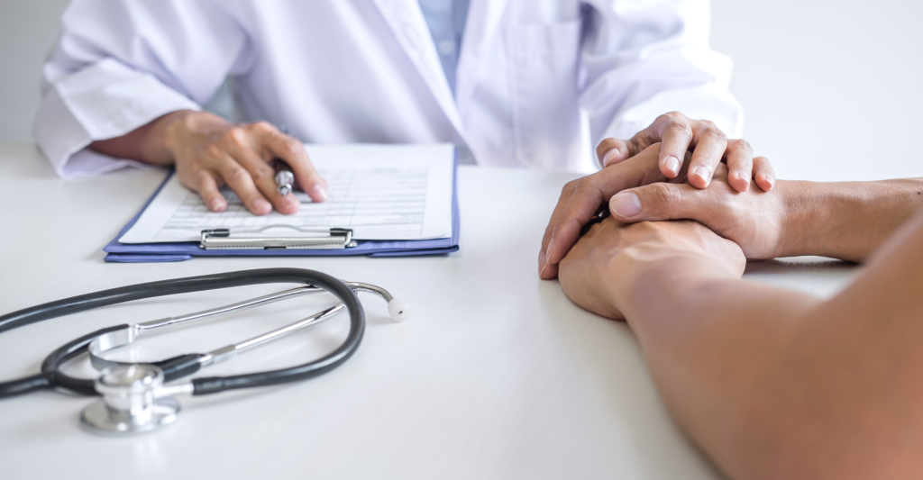 doctor holding woman's hand