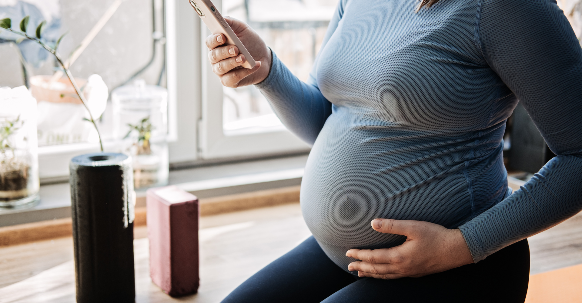 Pregnant woman holding phone