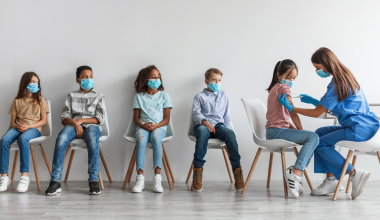 Children lining up for vaccines
