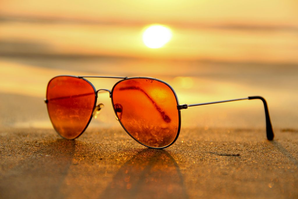 Sunglasses on a beach. Sunglasses can offer UV protection for your eyes.