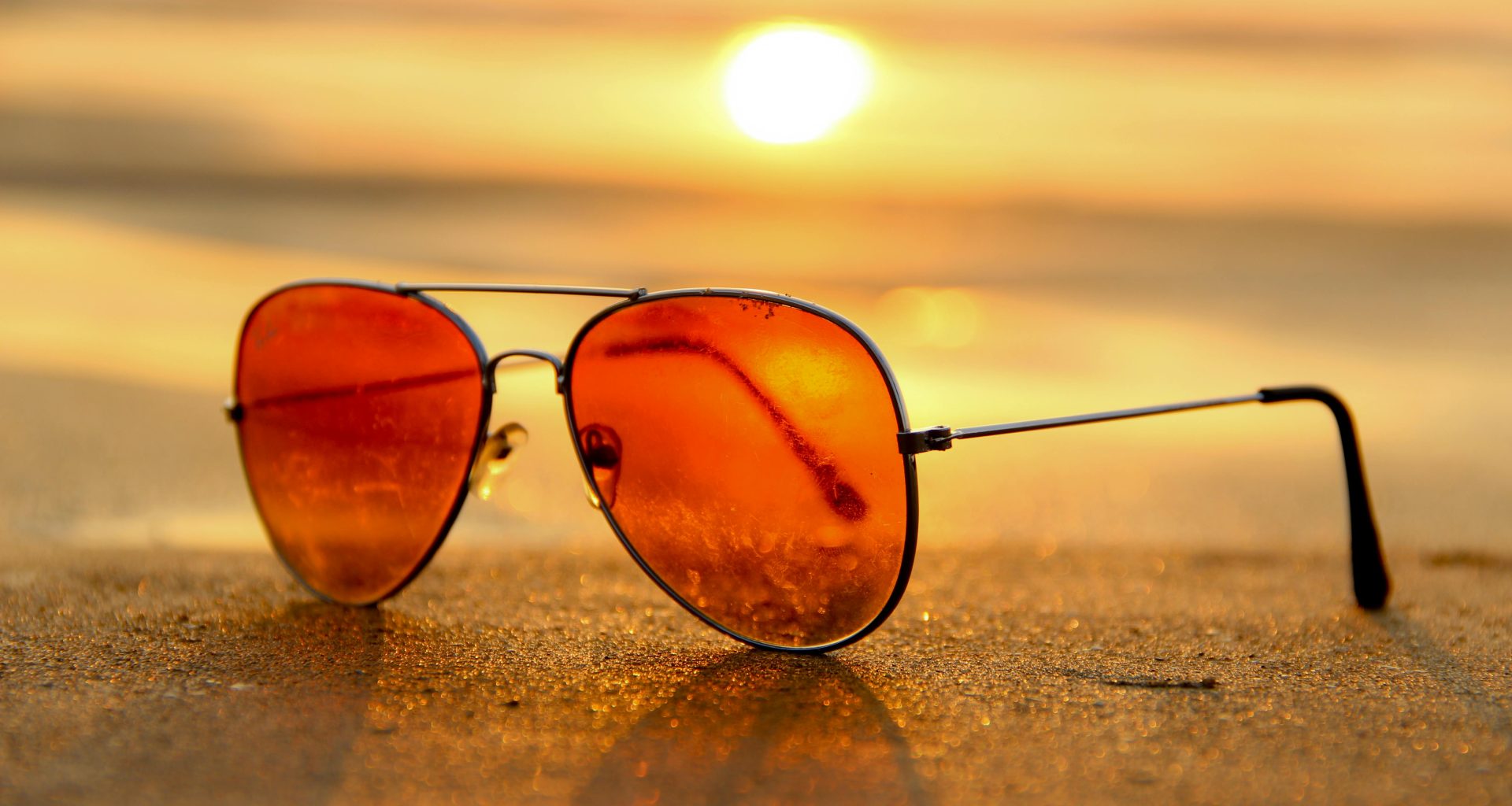 Sunglasses on a beach. Sunglasses can offer UV protection for your eyes.